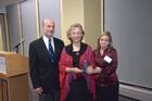 Dean Louis Goodman (l) and SIS Alumni Chapter Vice Chair Nikki Graham, SIS/BA '01 (r) present Dr. Linda Lucia Lubrano (c) with her award. Photo courtesy of Jeff Watts.
